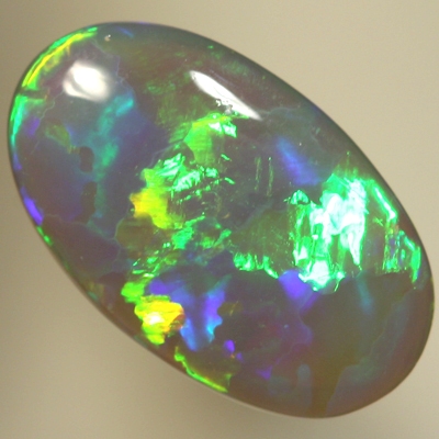 SOLID SEMI BLACK OPAL Very bright rolling flashes of neon green, orange, and purple. SEE VIDEO